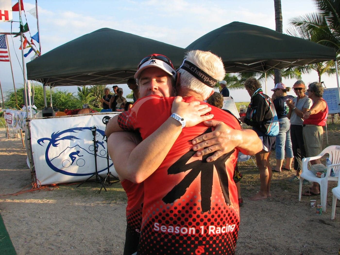 Rusty embracing their father at the finish of their first Ultraman in Hawaii.